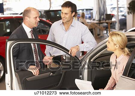 Couple buying new car View Large Photo Image Stock Image - Couple buying new car. Fotosearch