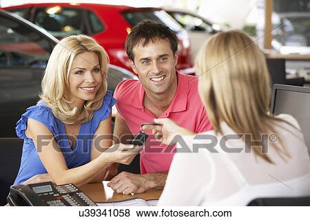 Couple buying new car View Large Photo Image Stock Photo - Couple buying new car. Fotosearch