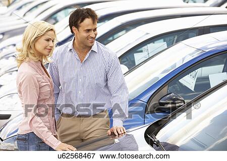 Stock Photo - Couple buying new car. Fotosearch