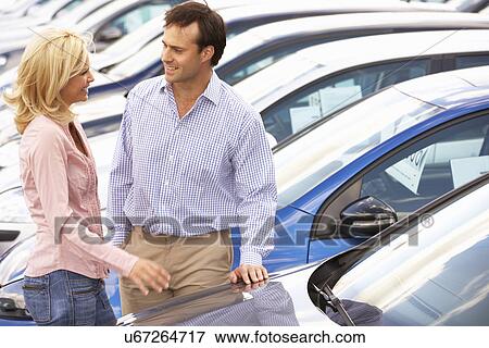 Couple buying new car View Large Photo Image Stock Photo - Couple buying new car. Fotosearch