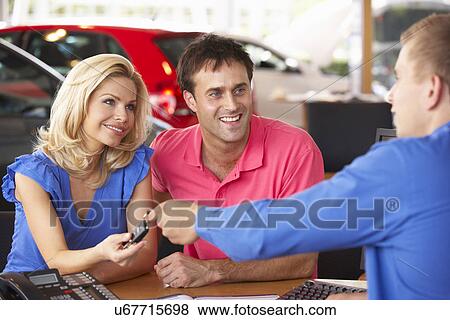 Couple buying new car View Large Photo Image Stock Photo - Couple buying new car. Fotosearch