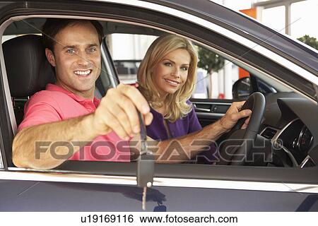 Couple buying new car View Large Photo Image Stock Photograph - Couple buying new car. Fotosearch