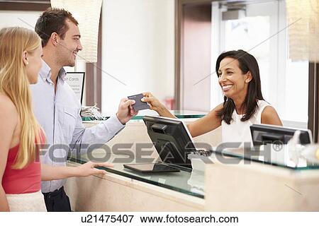 Couple Checking In At Hotel Reception View Large Photo Image Stock Photo - Couple Checking In At Hotel Reception. Fotosearch