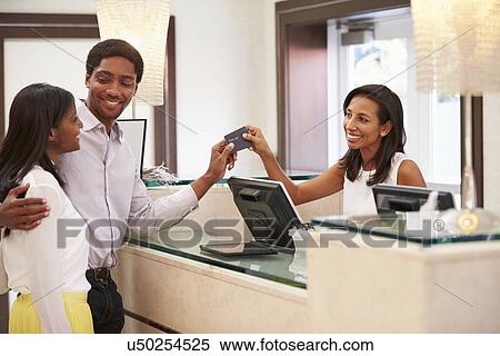 Couple Checking In At Hotel Reception View Large Photo Image Stock Photography - Couple Checking In At Hotel Reception. Fotosearch