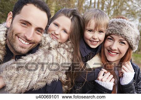 Stock Image - Couple Cycling Through Urban Park Together. Fotosearch