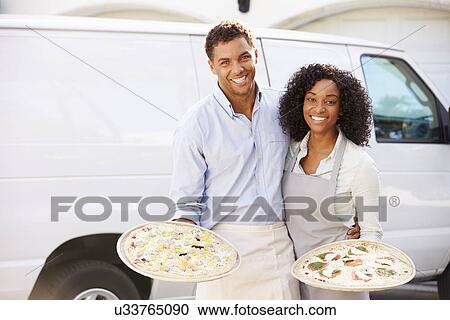 Couple Delivering Pizza Standing In Front Of Van View Large Photo Image Stock Image - Couple Delivering Pizza Standing In Front Of Van. Fotosearch
