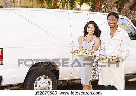 Couple Delivering Pizza Standing In Front Of Van View Large Photo Image Stock Image - Couple Delivering Pizza Standing In Front Of Van. Fotosearch