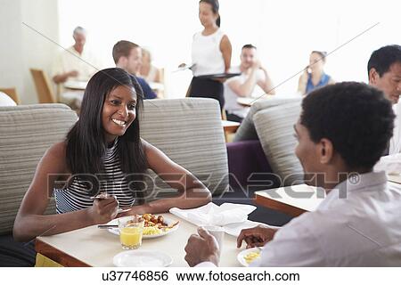 Stock Photograph - Couple Enjoying Breakfast In Hotel Restaurant. Fotosearch