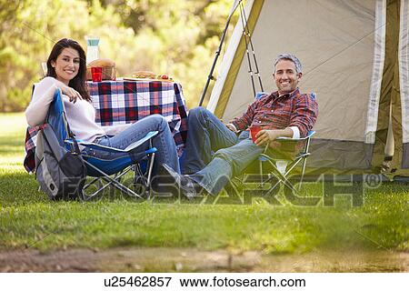 Stock Photo - Couple Enjoying Camping Holiday In Countryside. Fotosearch