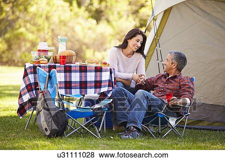 Stock Photo - Couple Enjoying Camping Holiday In Countryside. Fotosearch