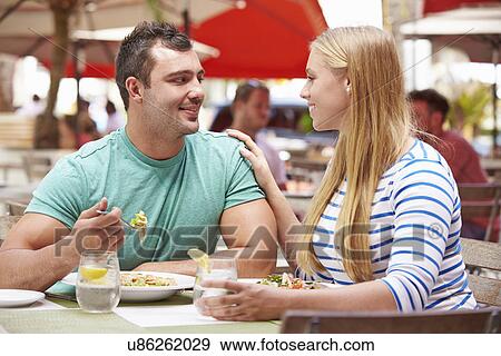 Stock Photo - Couple Enjoying Lunch In Outdoor Restaurant. Fotosearch