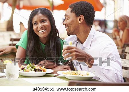 Stock Photography - Couple Enjoying Lunch In Outdoor Restaurant. Fotosearch