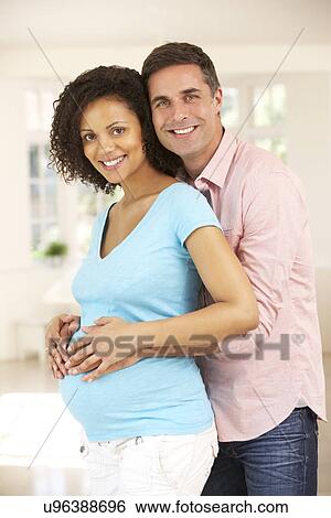 Stock Photograph - Couple expecting baby. Fotosearch