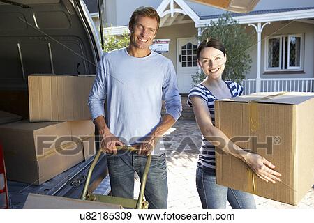 Couple moving house View Large Photo Image Stock Photo - Couple moving house. Fotosearch
