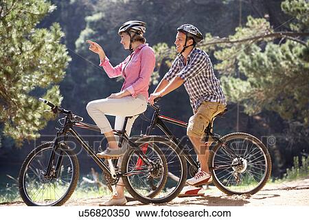 Couple on country bike ride View Large Photo Image Stock Image - Couple on country bike ride. Fotosearch