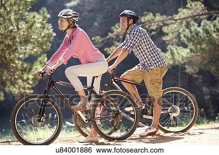 Stock Photograph - Couple on country bike ride. Fotosearch