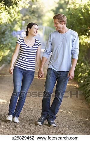 Stock Image - Couple on country walk. Fotosearch