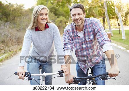 Picture - Couple On Cycle Ride In Countryside. Fotosearch