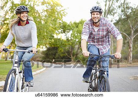 Stock Photograph - Couple On Cycle Ride In Countryside. Fotosearch