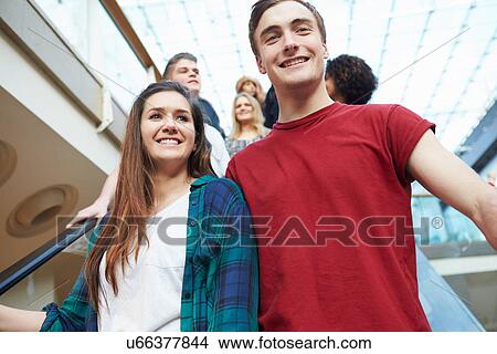 Couple On Escalator In Shopping Mall Together View Large Photo Image Picture - Couple On Escalator In Shopping Mall Together. Fotosearch