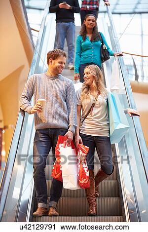 Couple On Escalator In Shopping Mall Together View Large Photo Image Stock Image - Couple On Escalator In Shopping Mall Together. Fotosearch