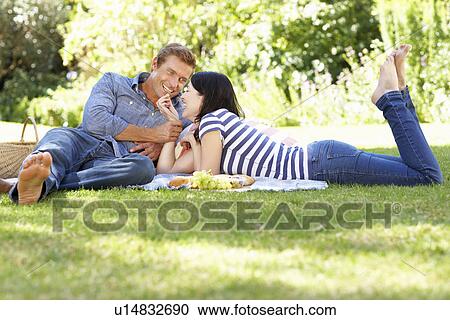 Stock Image - Couple on romantic picnic. Fotosearch