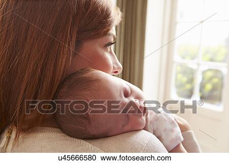 Stock Image - Couple On Roof Terrace Using Digital Tablet. Fotosearch