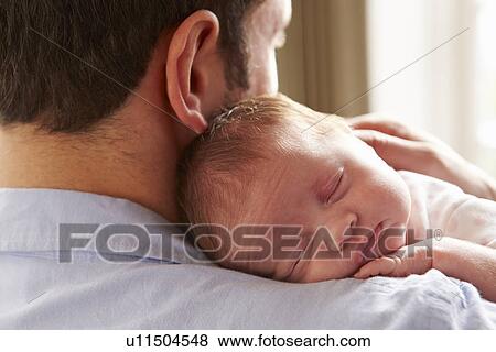 Stock Photo - Couple On Roof Terrace Using Digital Tablet. Fotosearch