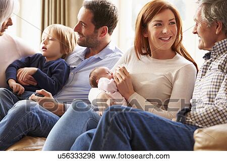 Stock Photo - Couple On Roof Terrace Using Laptop And Digital Tablet. Fotosearch