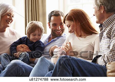 Stock Photo - Couple On Roof Terrace Using Laptop And Digital Tablet. Fotosearch