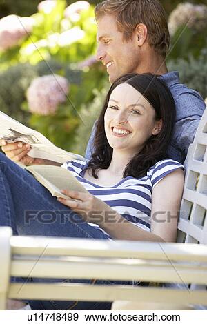 Couple reading in garden View Large Photo Image Stock Photo - Couple reading in garden. Fotosearch