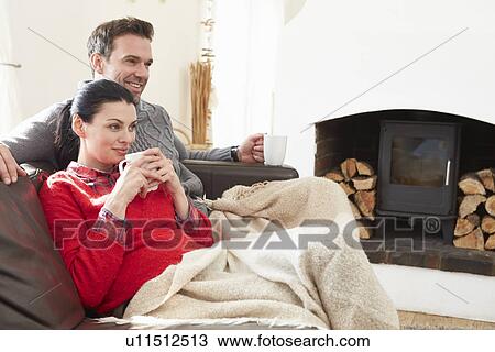 Couple Relaxing At Home Watching Television View Large Photo Image Stock Image - Couple Relaxing At Home Watching Television. Fotosearch