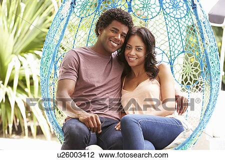 Couple Relaxing On Outdoor Garden Swing Seat View Large Photo Image Stock Image - Couple Relaxing On Outdoor Garden Swing Seat. Fotosearch