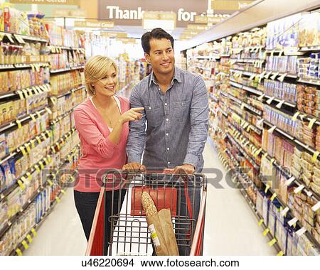 Couple shopping in supermarket View Large Photo Image Picture - Couple shopping in supermarket. Fotosearch