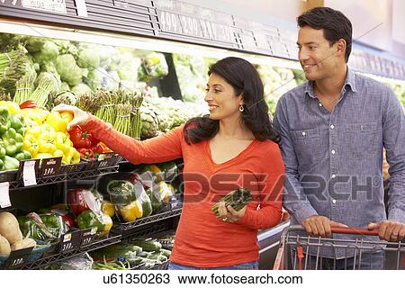 Couple shopping in supermarket View Large Photo Image Stock Image - Couple shopping in supermarket. Fotosearch