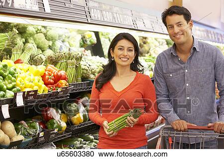 Couple shopping in supermarket View Large Photo Image Stock Image - Couple shopping in supermarket. Fotosearch