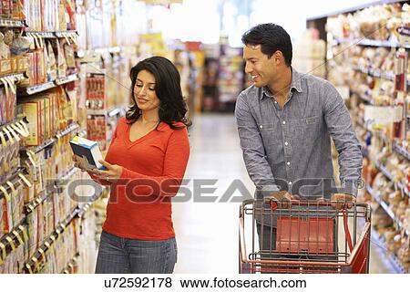 Stock Photo - Couple shopping in supermarket. Fotosearch