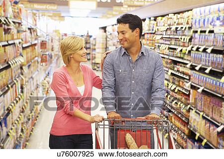Couple shopping in supermarket View Large Photo Image Stock Photography - Couple shopping in supermarket. Fotosearch