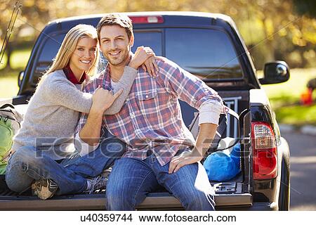 Picture - Couple Sitting In Pick Up Truck On Camping Holiday. Fotosearch