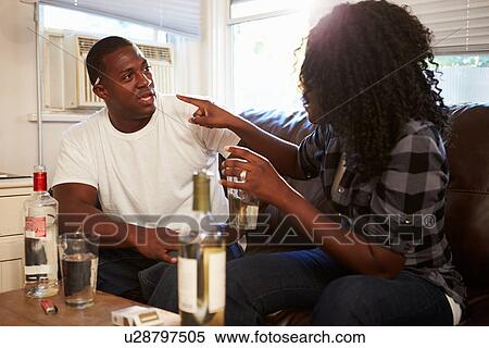 Couple Sitting On Sofa Drinking Alcohol And Arguing View Large Photo Image Stock Photography - Couple Sitting On Sofa Drinking Alcohol And Arguing. Fotosearch