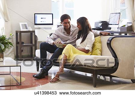 Couple Sitting On Sofa In Hotel Lobby View Large Photo Image Stock Image - Couple Sitting On Sofa In Hotel Lobby . Fotosearch