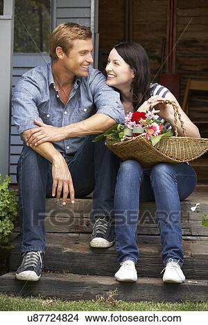 Couple sitting on veranda View Large Photo Image Picture - Couple sitting on veranda. Fotosearch