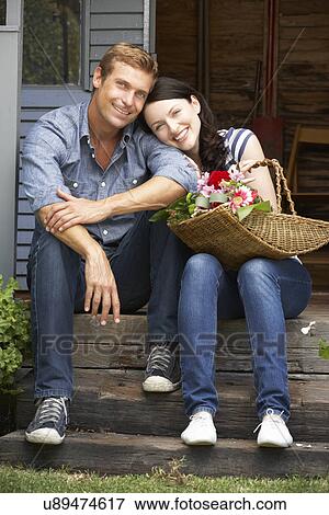 Stock Photo - Couple sitting on veranda. Fotosearch