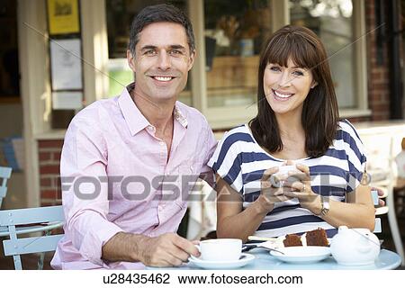 Stock Image - Couple sitting outside café. Fotosearch