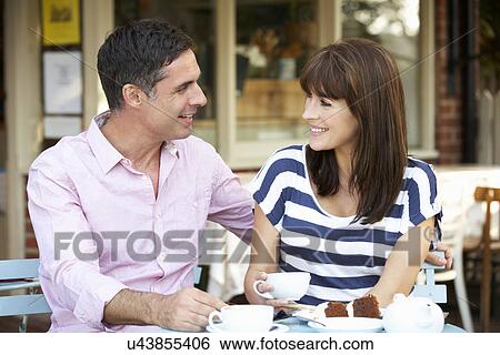 Stock Photograph - Couple sitting outside café. Fotosearch