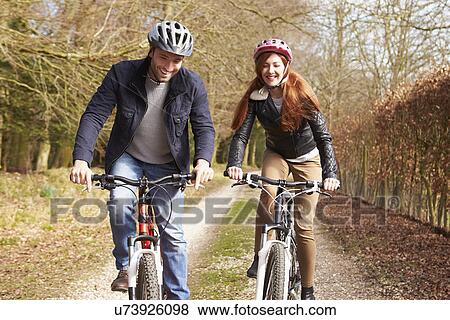 Stock Photo - Couple Taking Dog For Walk On City Street. Fotosearch