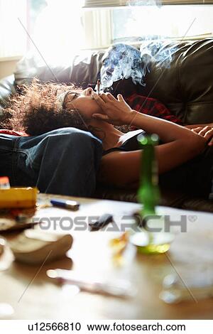 Stock Image - Couple Taking Drugs At Home Together. Fotosearch