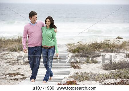 Couple walking by the sea View Large Photo Image Stock Image - Couple walking by the sea. Fotosearch