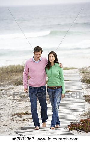 Couple walking by the sea View Large Photo Image Stock Image - Couple walking by the sea. Fotosearch