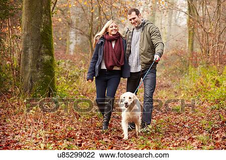 Couple Walking Dog Through Winter Woodland View Large Photo Image Stock Image - Couple Walking Dog Through Winter Woodland. Fotosearch